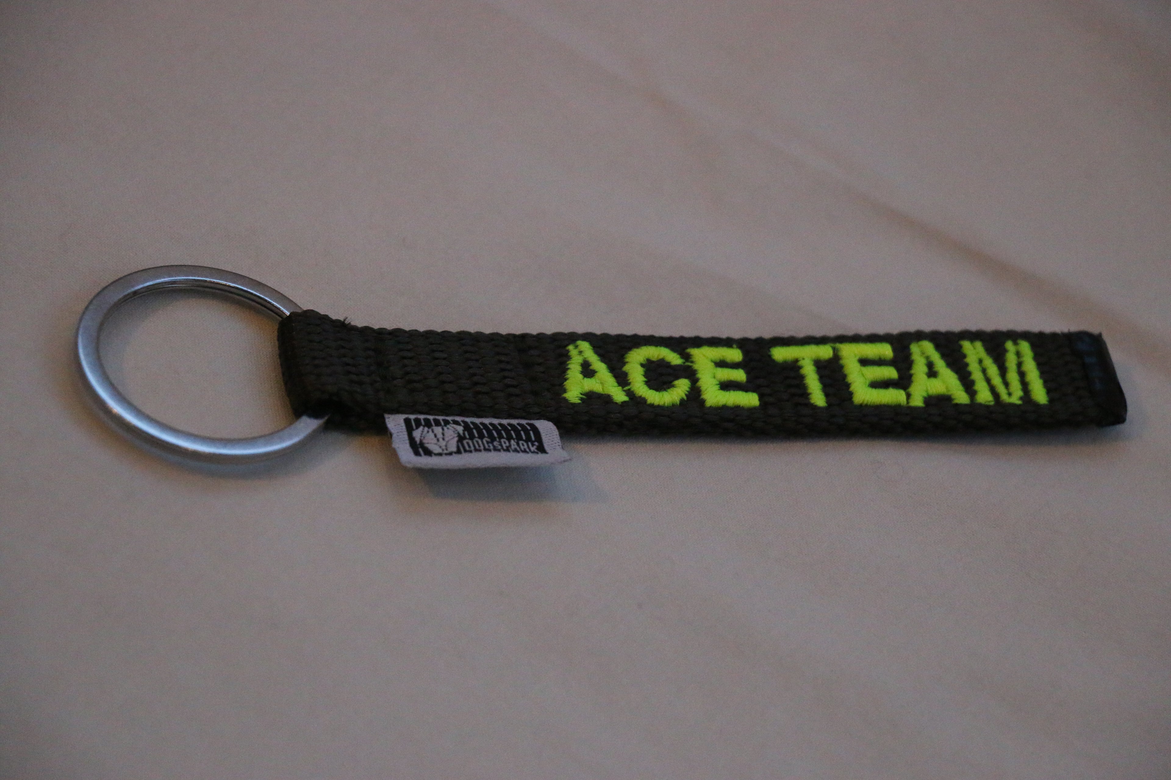 DOGsPARK Custom embroidered keychain olive with neon yellow embroidery text. Handmade in Portugal
